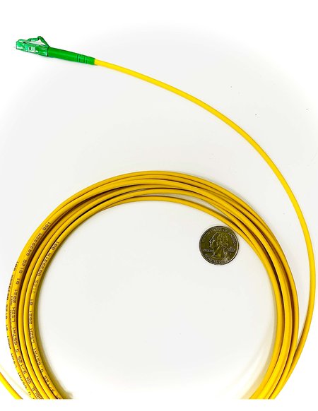A yellow coiled cable with a quarter