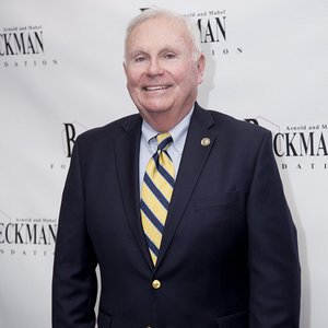 A portrait of Bill May wearing a suit.