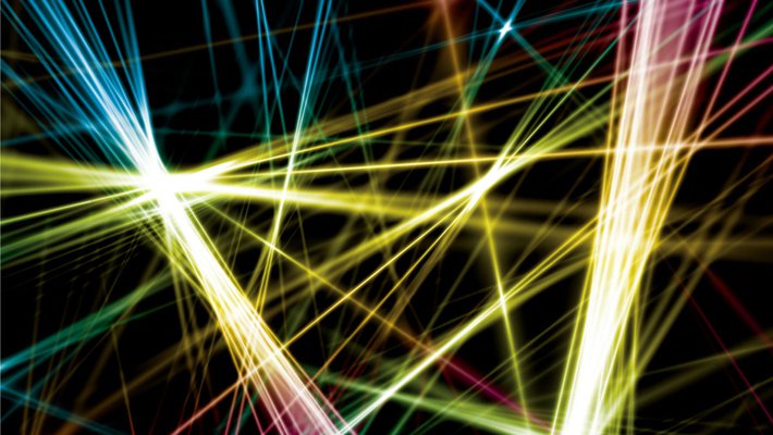 An artist's rendition of multi-colored laser beams chaotically arranged in front of a black background.