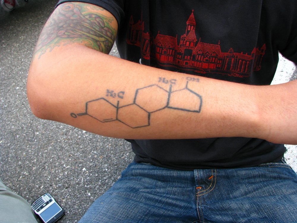 A man's forearm with a tattoo of the testosterone molecule