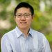 Portrait of Yimeng Li in a striped shirt with green out-of-focus background