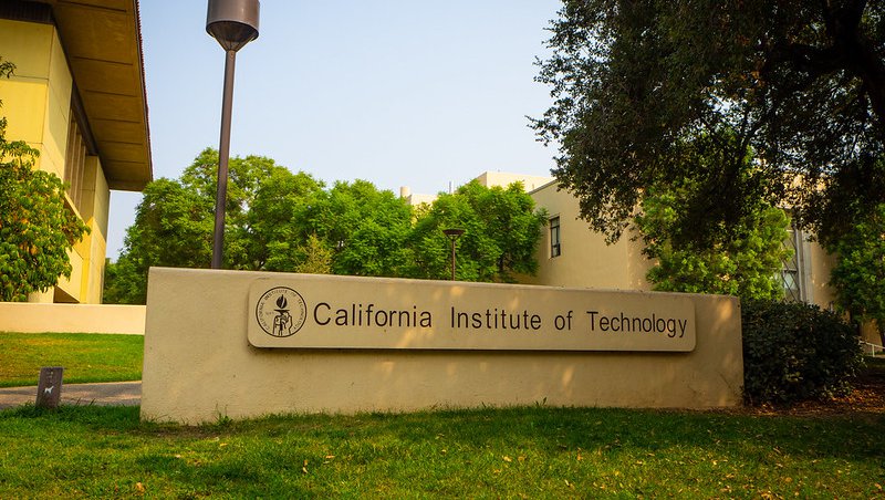 Photo of the entrance of Caltech's campus with a sign reading California Institute of Technology