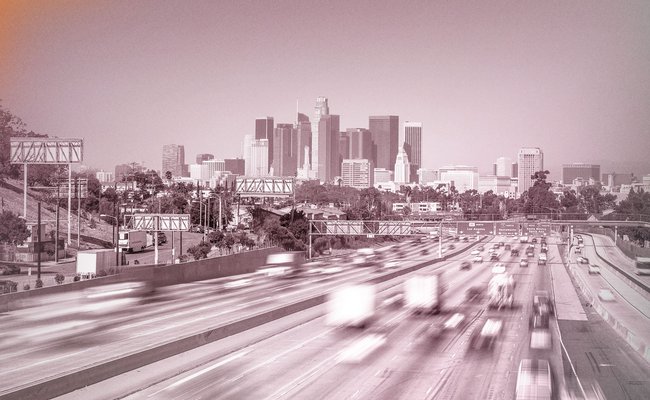 Time-lapse photo of Los Angeles traffic and skyscrapers