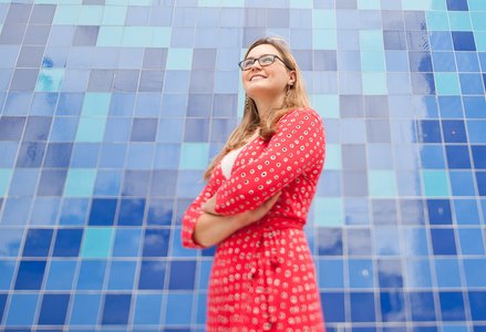 Erin Hartman poses in front of a wall