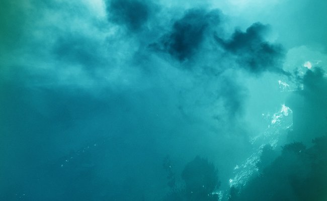 teal duotone filtered aerial image of smoke from wildfire