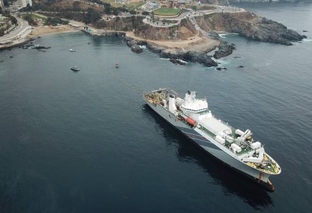 Large ship off a coastline
