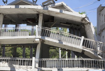 A concrete building collapses due to an earthquake