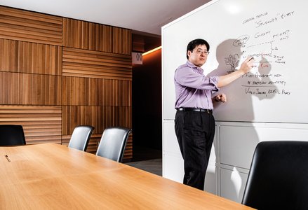 Sam Wang teaching at a Whiteboard