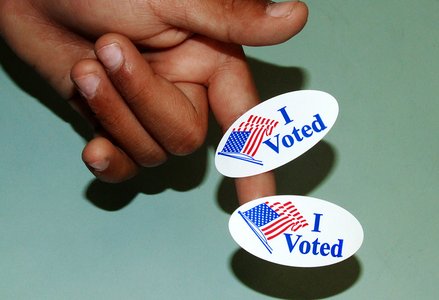 A person with two voting stickers
