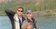 Holding a Mackinaw Trout (lake trout) on a small boat in the East Arm of Great Slave Lake, Northwest Territories, Canada