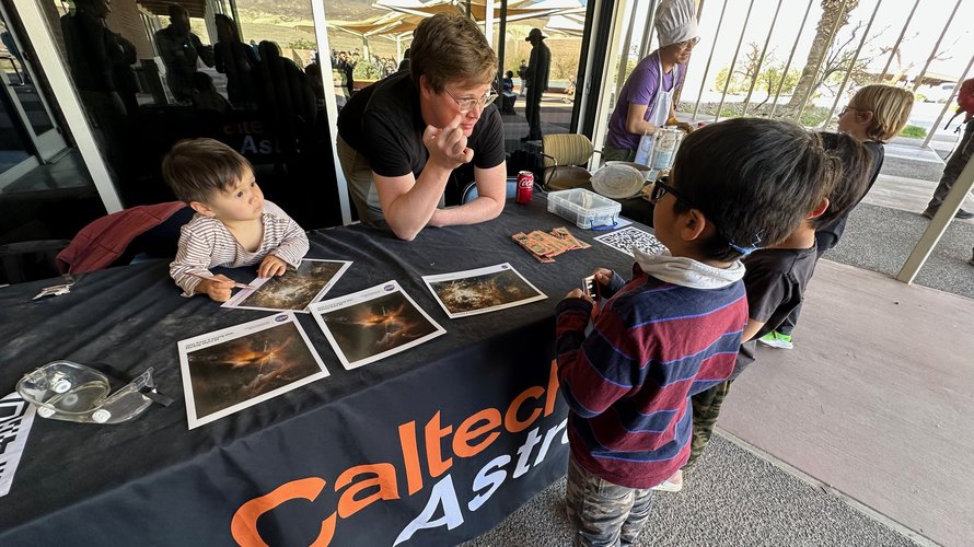 A man talks to a group of children about astronomy.