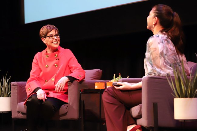 Diana Buchwald smiling on stage at her Watson Lecture.
