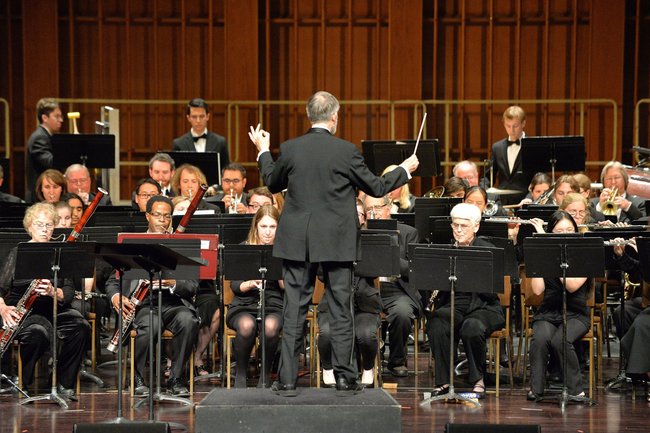The Caltech Wind Orchestra performing on stage.