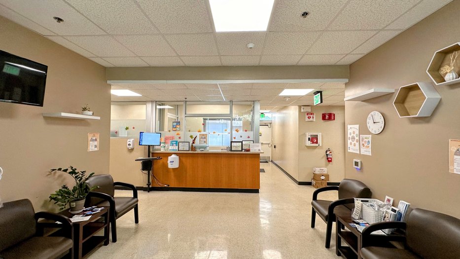 The lobby of Student Wellness Services showing the front desk and chairs