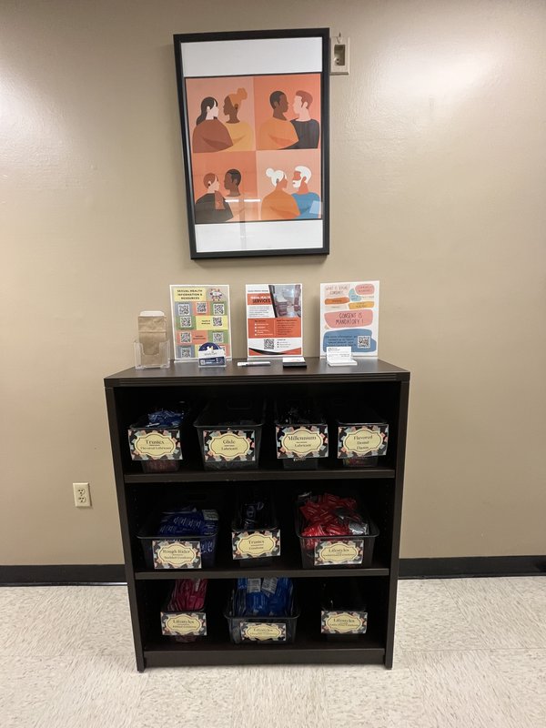 A bookshelf containing baskets of condoms and other barrier contraception